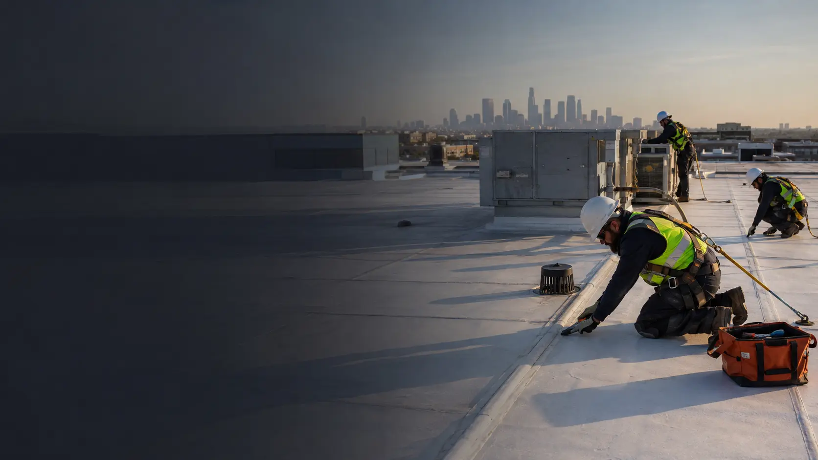 Commercial low-slope roof inspection with Los Angeles skyline in the distance